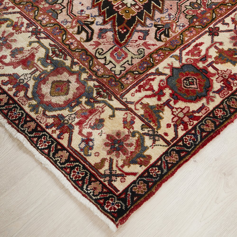 Close-up of a patterned Persian wool rug with intricate designs