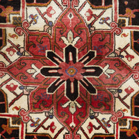 Close-up of a patterned Persian wool rug with red, black, and beige colours.