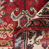 Close-up of a patterned Persian wool rug with intricate designs.