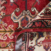Close-up of a patterned Persian wool rug with intricate designs.