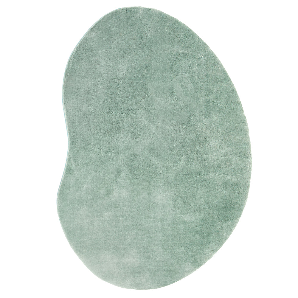 Asymmetrical pale green soft rug with smooth texture and modern organic shape.