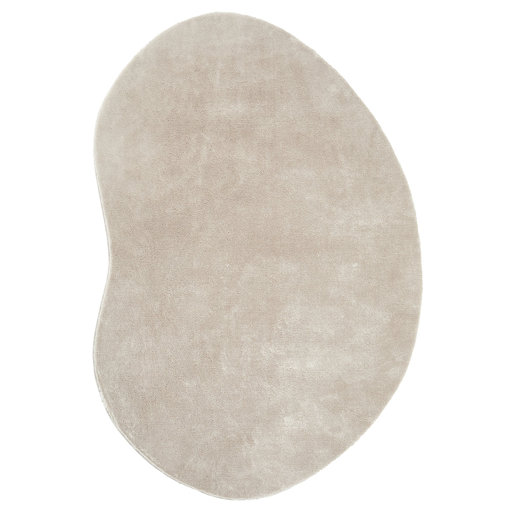 Soft pale beige bean-shaped rug with a smooth, plush texture and modern design.