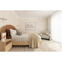 Modern bedroom with a bed, nightstands, and a chair.