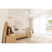 Modern bedroom with wooden bed, striped bedding, and large windows.