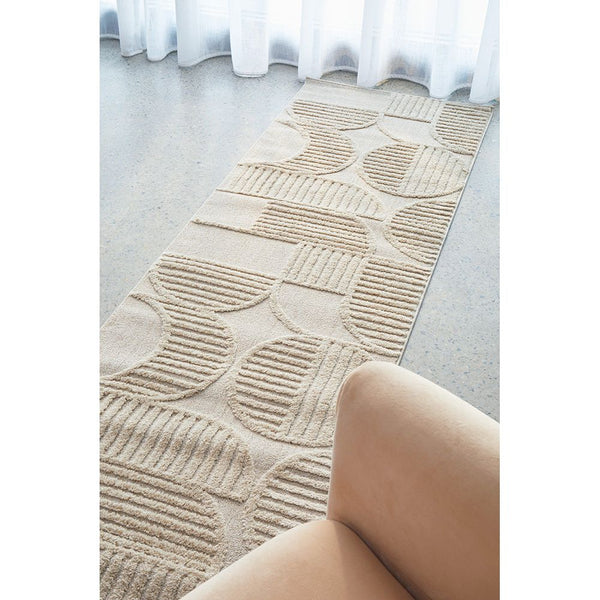 Beige runner rug with textured geometric pattern in modern neutral tones on polished floor.