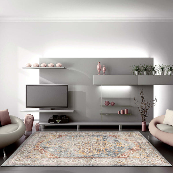Rectangular blue multi-colored traditional patterned rug with intricate floral and geometric motifs on a neutral living room