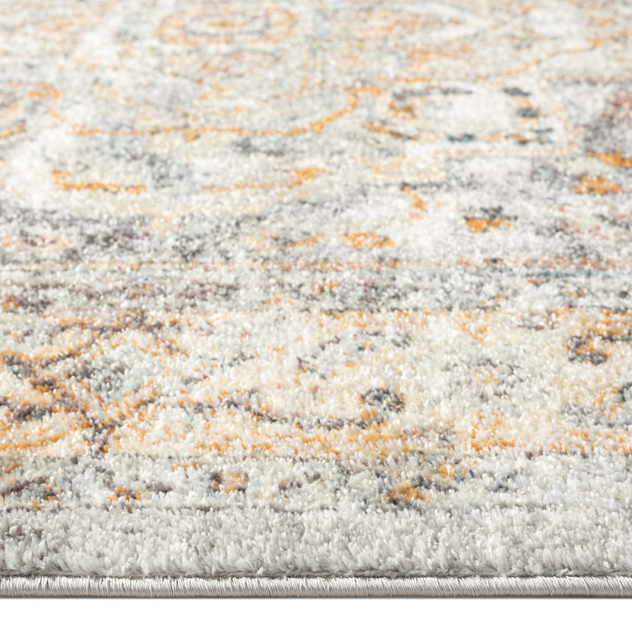 Close-up of blue multi-coloured traditional patterned runner rug with beige and orange accents.