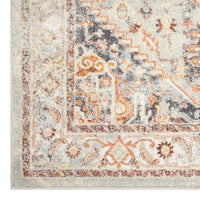 Traditional runner rug with intricate multi-colored patterns in beige, orange, gray, and brown tones.