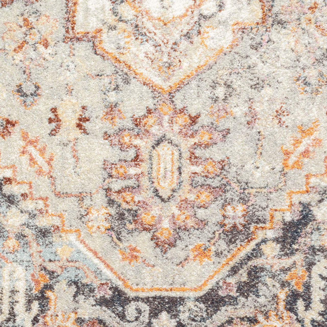 Multi-coloured traditional patterned runner rug with beige, orange, and dark grey geometric motifs.