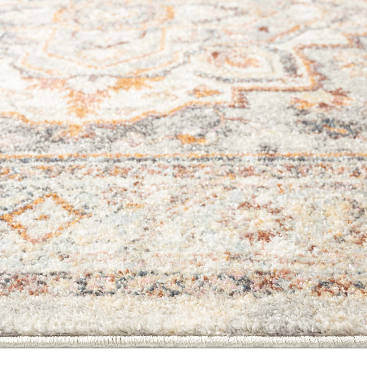 Soft polypropylene runner rug with muted traditional floral and geometric patterns in beige, gold, and grey tones.