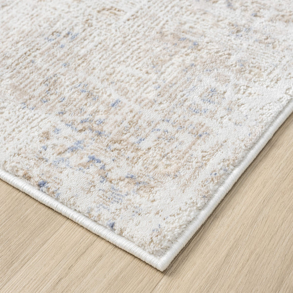 Beige and cream abstract textured rug with subtle multi-colored accents and a soft, woven finish.