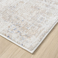Beige and cream abstract textured rug with subtle multi-colored accents and a soft, woven finish.