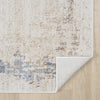 Beige and cream abstract textured rug with hints of blue and gray, corner folded to show backing.