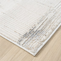 Beige and grey textured modern runner rug corner with subtle multi-color accents on light wood floor.