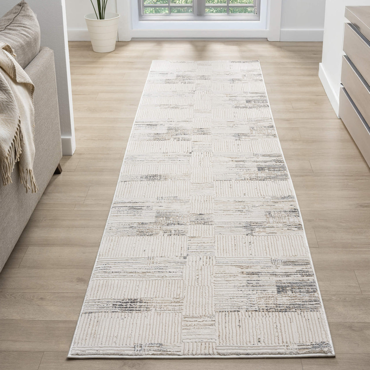 Beige and grey textured runner rug with modern geometric pattern on light wood floor.