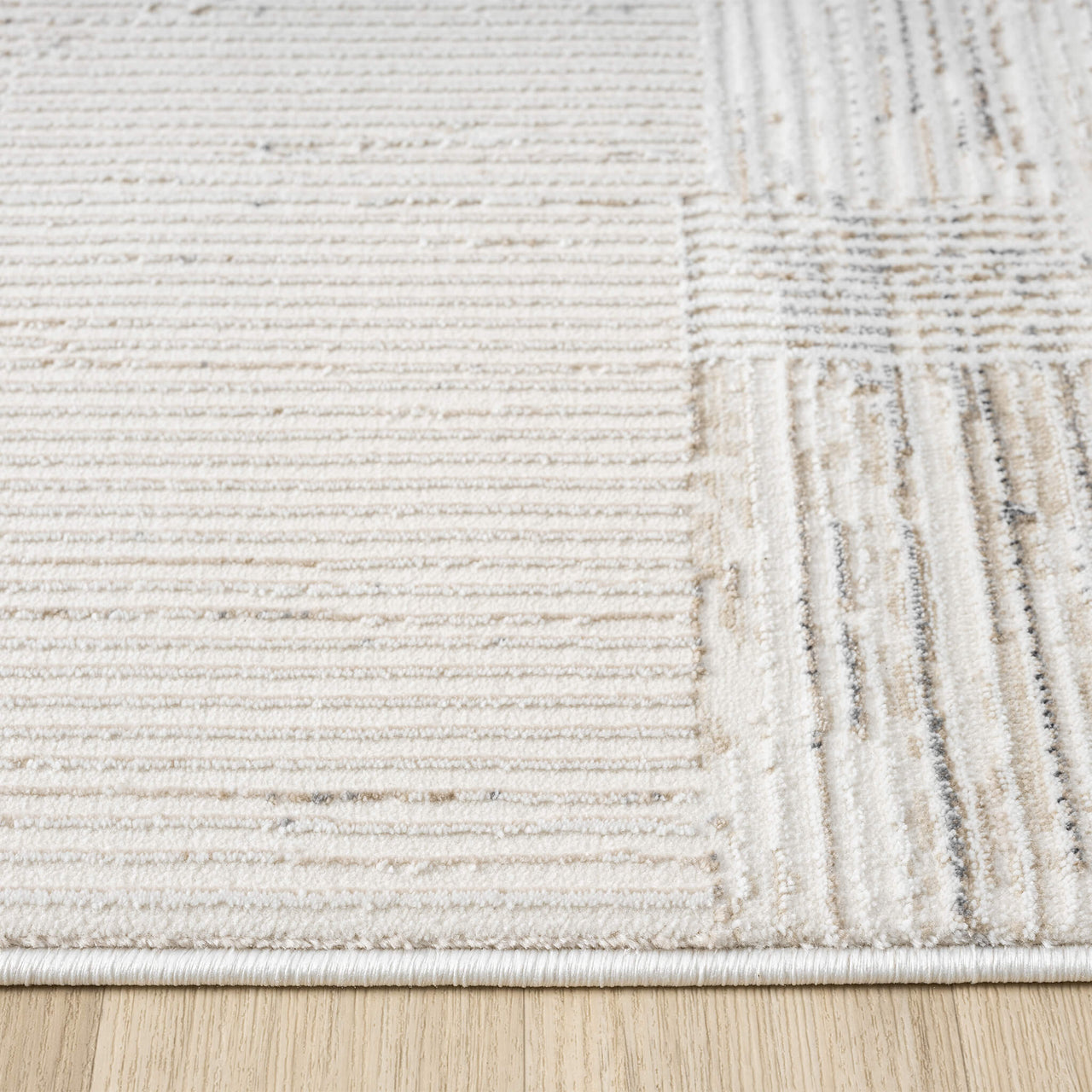 Beige and grey textured runner rug with striped and checkered patterns on wood floor.