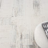 Beige and grey textured modern rug with subtle linear and grid patterns.