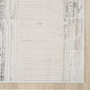 Beige and grey textured rug with linear and abstract patterns in a modern design.