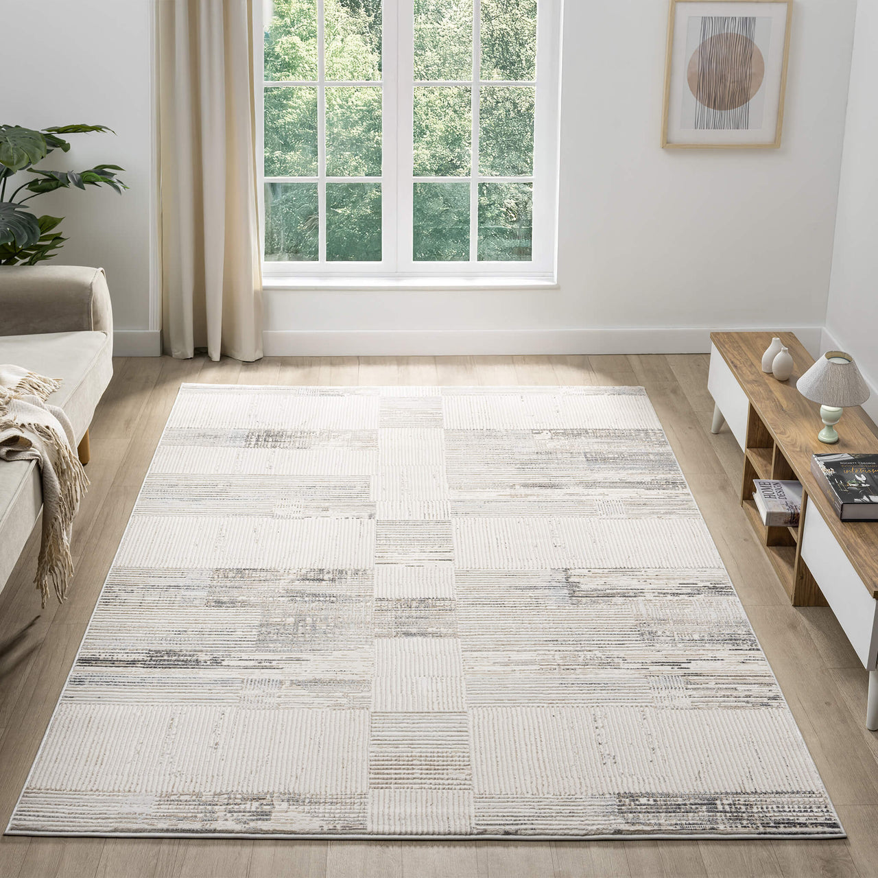 Beige and grey textured modern rug with abstract pattern in a bright, minimalist living room.