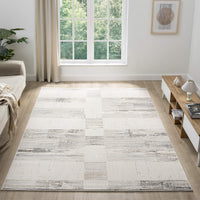 Beige and grey textured modern rug with abstract pattern in a bright, minimalist living room.