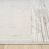 Beige and grey textured modern rug with striped and grid patterns on light background.