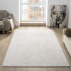 Beige and white modern rug with subtle geometric patterns on a light wood floor in a bright living room.