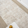 Beige and grey modern runner rug with subtle abstract pattern on hardwood floor.