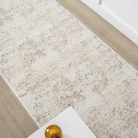 Beige and grey modern runner rug with subtle abstract pattern on hardwood floor.