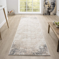 Beige grey modern runner rug with subtle abstract faded pattern on light wood floor.