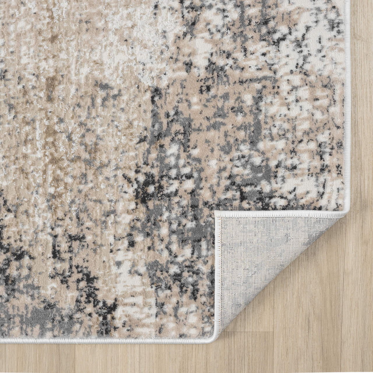 Beige and grey modern runner rug with abstract mottled pattern and piped edges on hardwood floor.