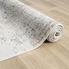 Rolled beige and grey modern runner rug with subtle abstract pattern on light wood floor.