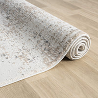 Rolled beige and grey modern runner rug with subtle abstract pattern on light wood floor.