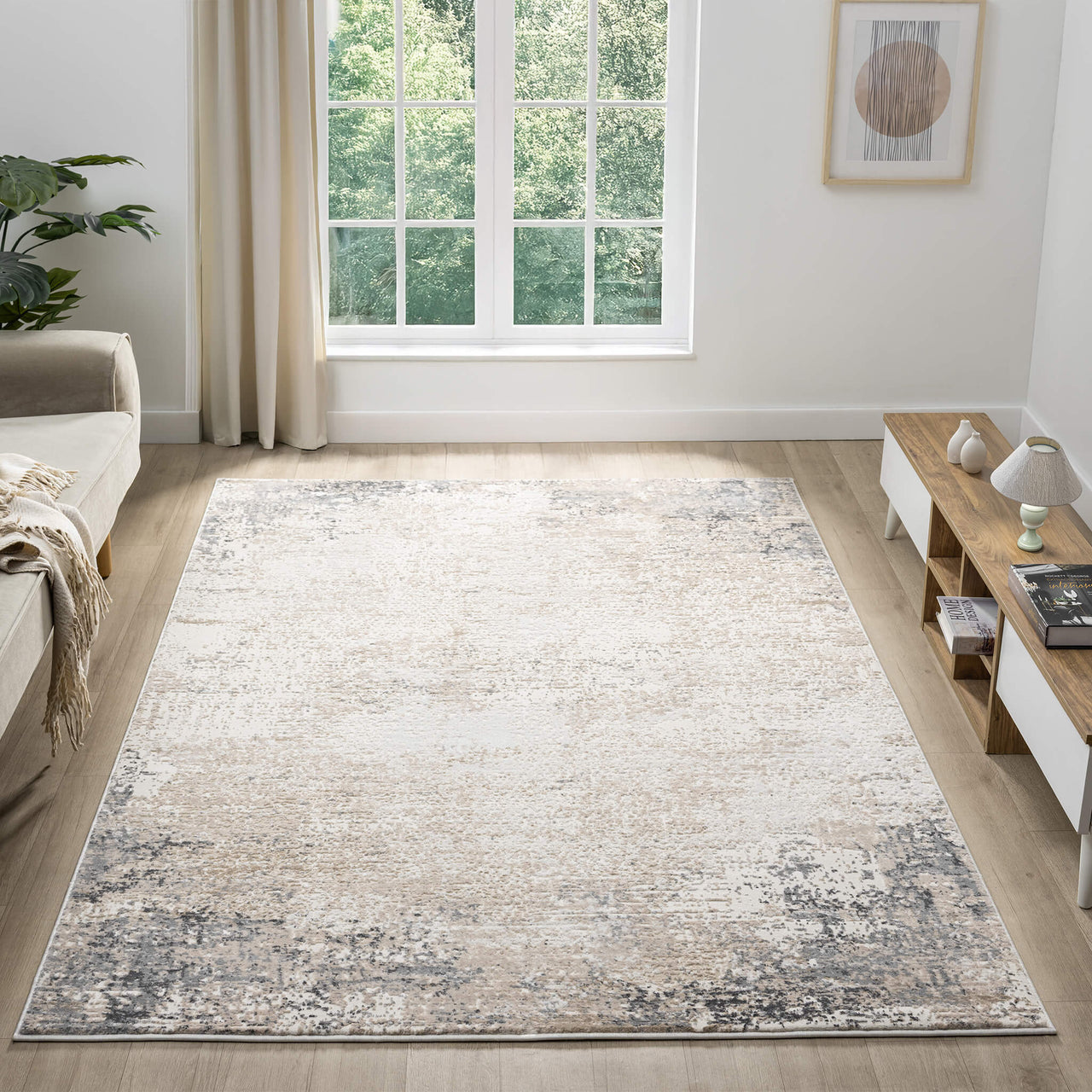 Beige and grey modern rug with subtle distressed pattern in a bright living room setting.