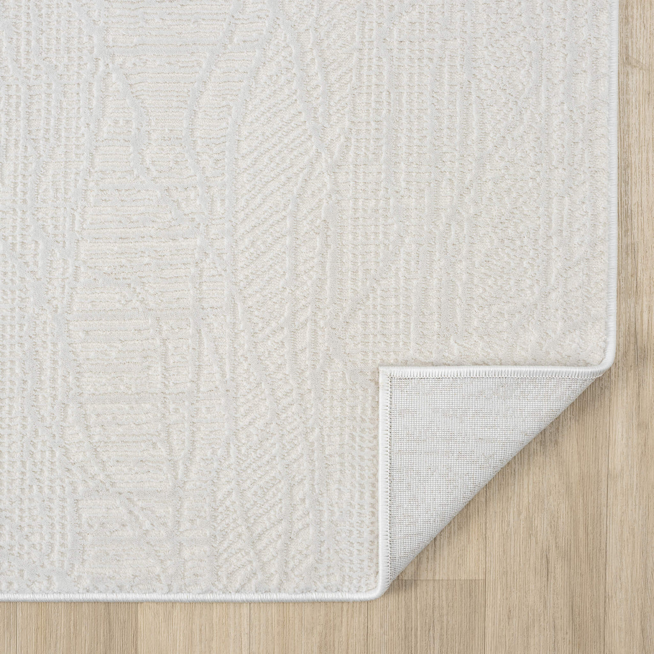 Cream modern runner rug with subtle textured pattern and power-loomed polyester blend.