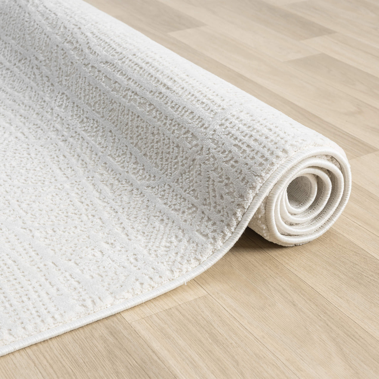 Cream textured modern runner rug with subtle geometric pattern on light wood floor.