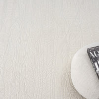 Cream modern rug with subtle textured linear pattern and soft woven surface.