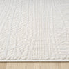 Cream modern rug with textured geometric patterns and soft, plush pile on wooden floor.