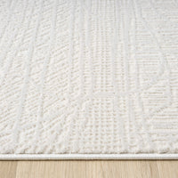 Cream modern rug with textured geometric patterns and soft, plush pile on wooden floor.