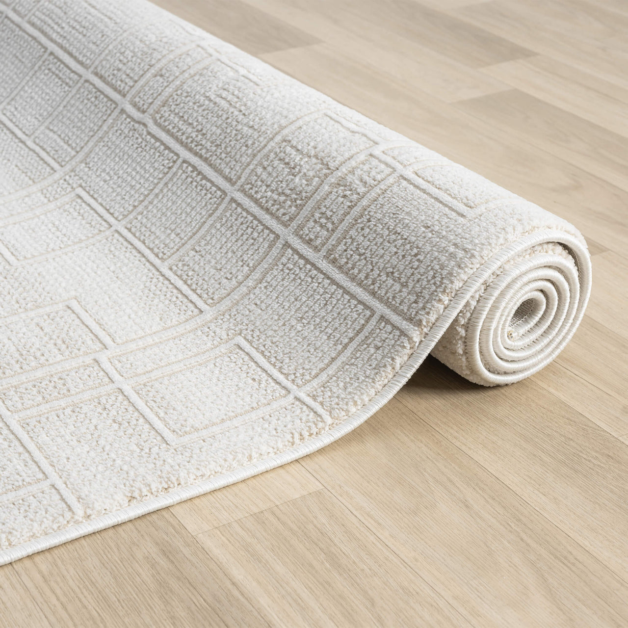 Cream modern runner rug with textured geometric square pattern on light hardwood floor.