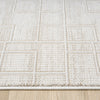 Cream runner rug with textured geometric square pattern on wooden floor.