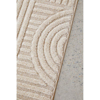Close-up of a textured beige rug on a concrete floor