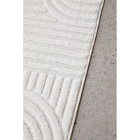 Textured white rug on a concrete floor