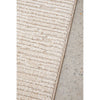 Textured beige rug on a concrete floor