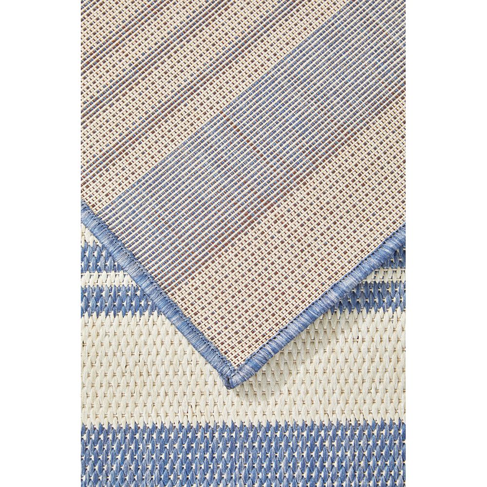 Textured rug with blue and beige pattern.