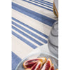 Blue and white striped rug with sliced oranges on a plate.