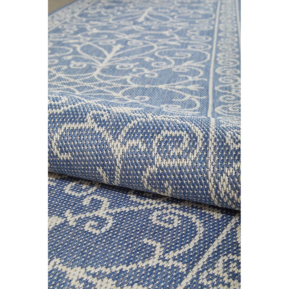 Close-up of a blue and white patterned outdoor runner rug