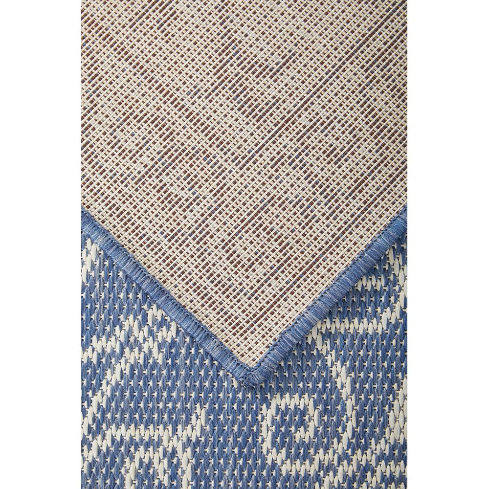 Runner rug with geometric pattern transitioning from beige to blue