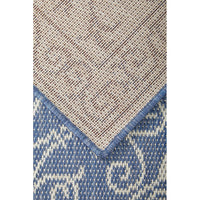 Runner rug with geometric pattern transitioning from beige to blue