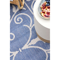 Blue and white patterned rug with a side view of a table setting.