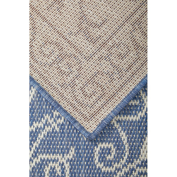 Rug with geometric pattern transitioning from beige to blue